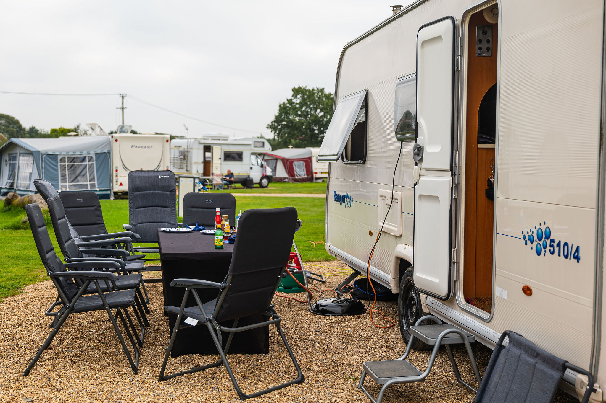 Your caravan holiday packing list | Caravan with table and chairs outside