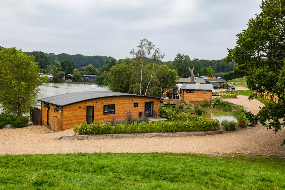 Glamping in west sussex | Luxury camping lodge on the side of a lake.